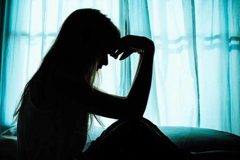 A sick woman ponders in bed